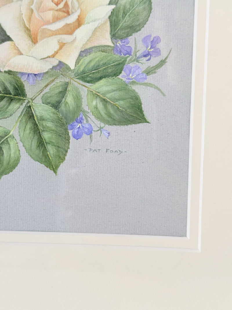 Framed pencil drawing of pale yellow and blush roses with green leaves and purple flowers on a soft grey background, signed by artist Pam Ford.