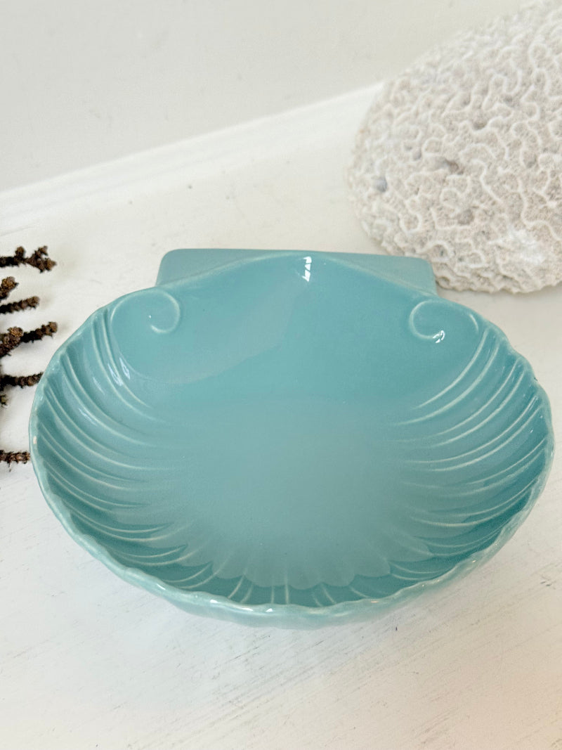 Poole Pottery scallop shell serving dish in sea blue glaze photographed on a white surface