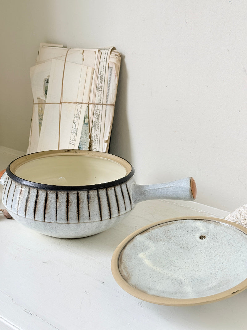 Denby Studio large two handled lidded casserole in grey and rust photographed on a white surface
