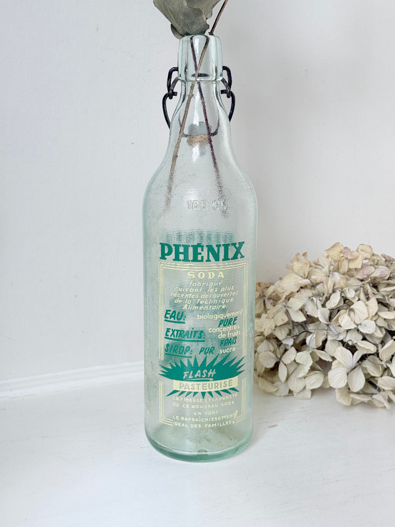 vintage french soda bottle phenix aqua green glass with ceramic swing top 31cm on white surface