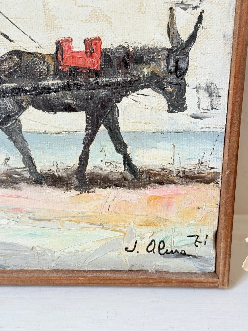 Vintage framed oil painting of horse and cart scene signed L. Cabanes photographed on a white surface