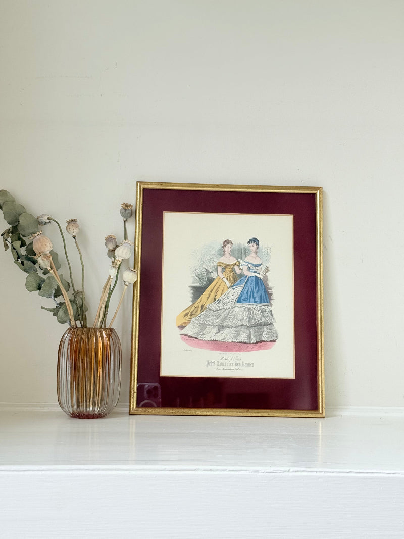 Vintage Modes de Paris fashion plate with gilt frame and burgundy mount, photographed on white surface