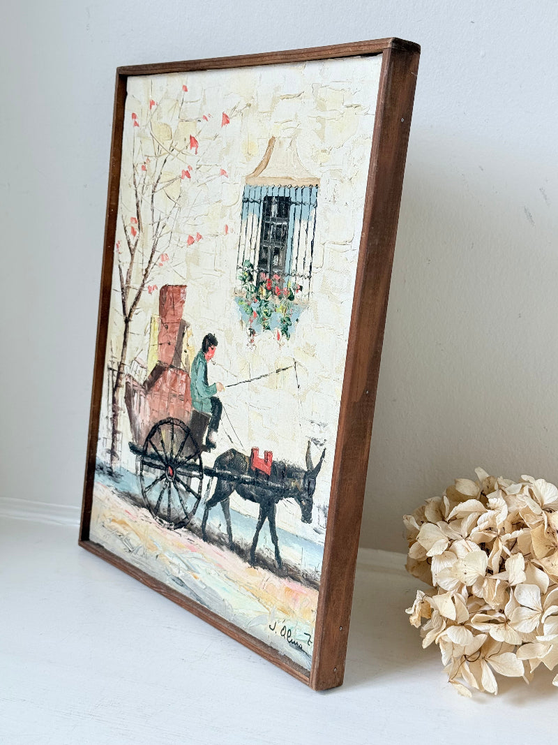 Vintage framed oil painting of horse and cart scene signed L. Cabanes photographed on a white surface