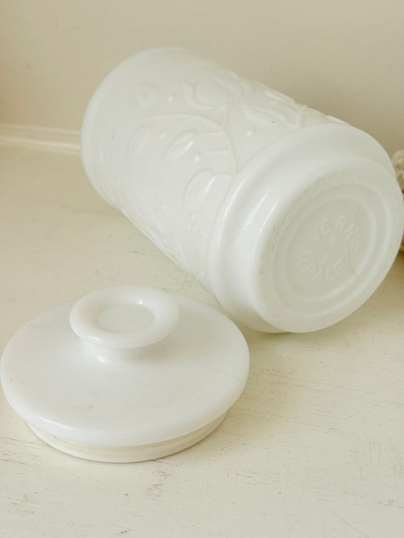 French opale glass jar with floral raised design, white vintage milk glass, shown on white background