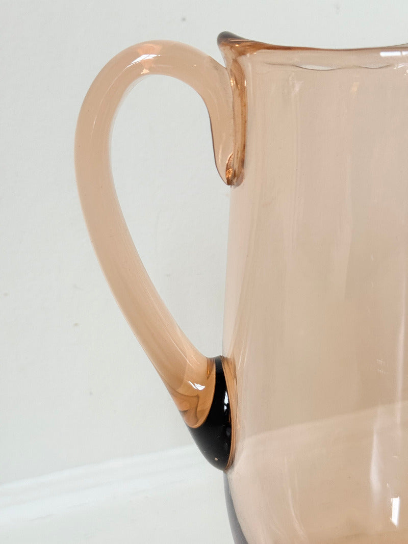 retro apricot glass serving jug with curved handle and flared spout, photographed on white surface