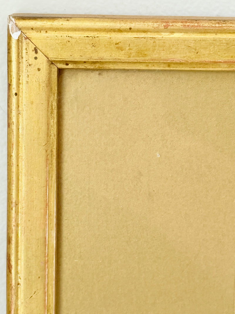 Framed vintage watercolour of countryside farm buildings with red roofs in gold frame photographed on a white surface