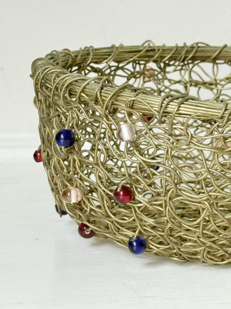 Vintage brass wire basket with coloured glass beads, photographed from multiple angles on a white surface