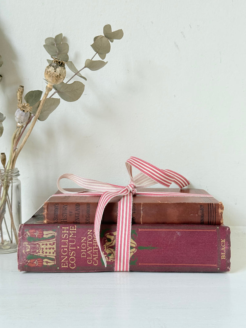 Vintage book bundle of English Costume and History of England with burgundy and brown hardback covers, photographed on a white surface