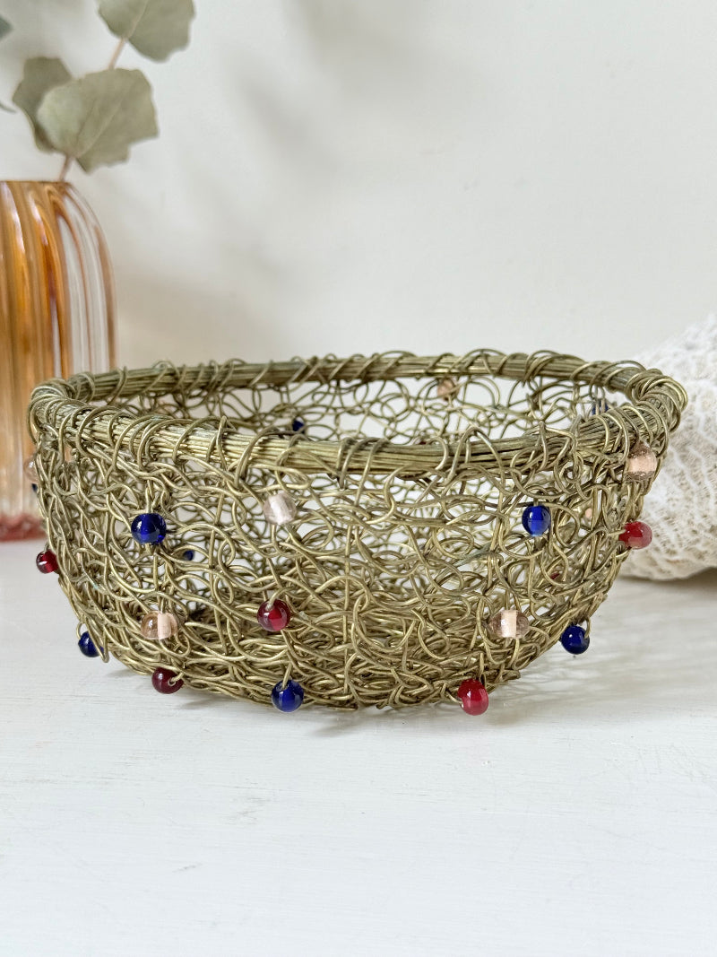 Vintage brass wire basket with coloured glass beads, photographed from multiple angles on a white surface