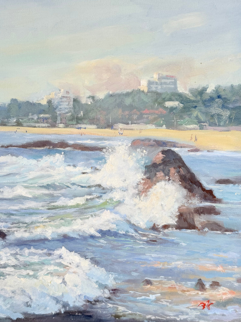 Original oil painting of waves crashing against rocks, signed seascape in slate blue wooden frame on white surface