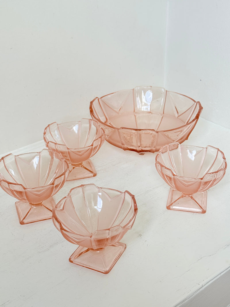 Art Deco pink pressed glass dessert service with scalloped serving bowl and four footed sundae dishes