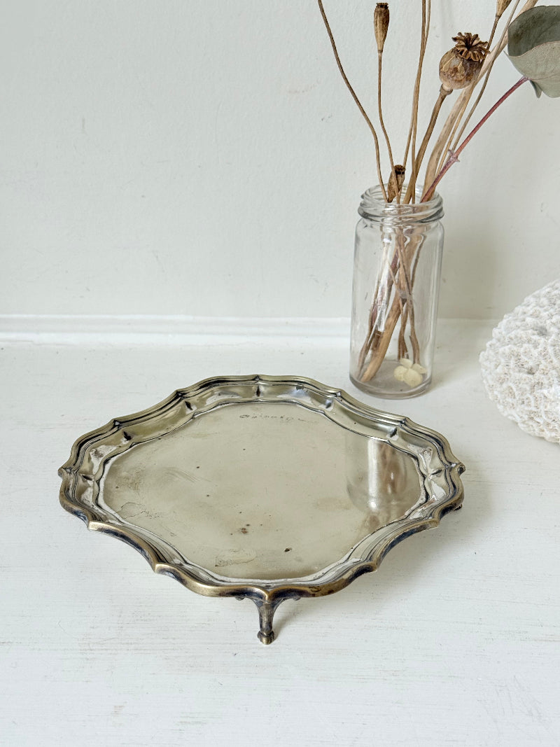 Vintage silver plate tray with scalloped edge and footed base, photographed on a white surface