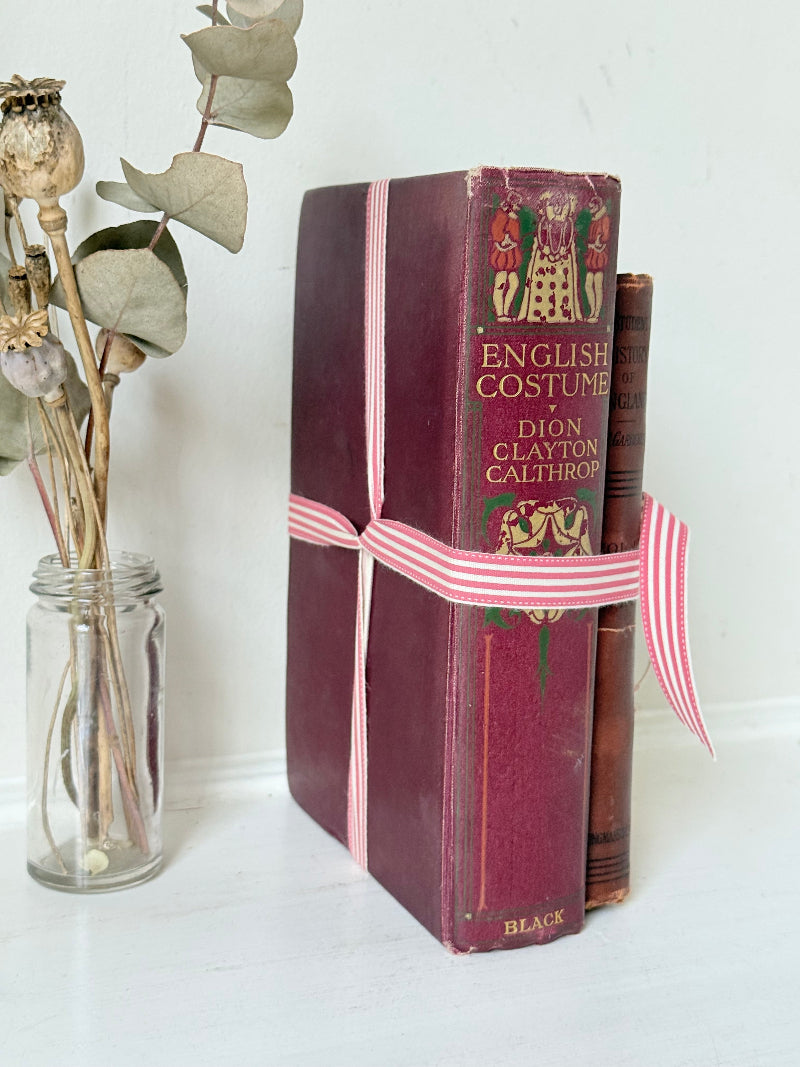 Vintage book bundle of English Costume and History of England with burgundy and brown hardback covers, photographed on a white surface