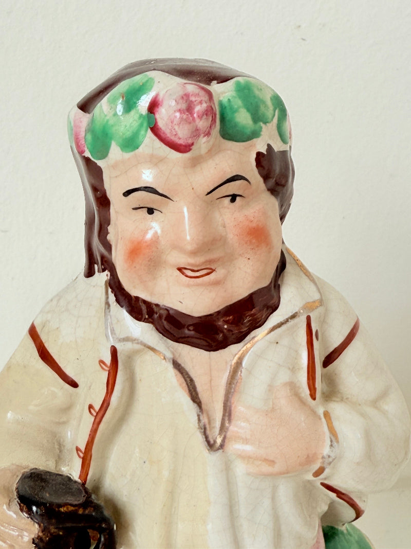 Bacchus antique Staffordshire pottery figure with painted details, photographed on a white surface.