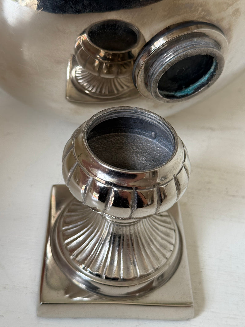 Vintage polished metal champagne bowl with pedestal base, photographed on a white surface
