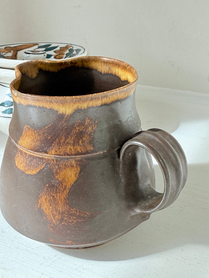 Studio pottery creamer and hand painted sugar bowl set, photographed on a white surface