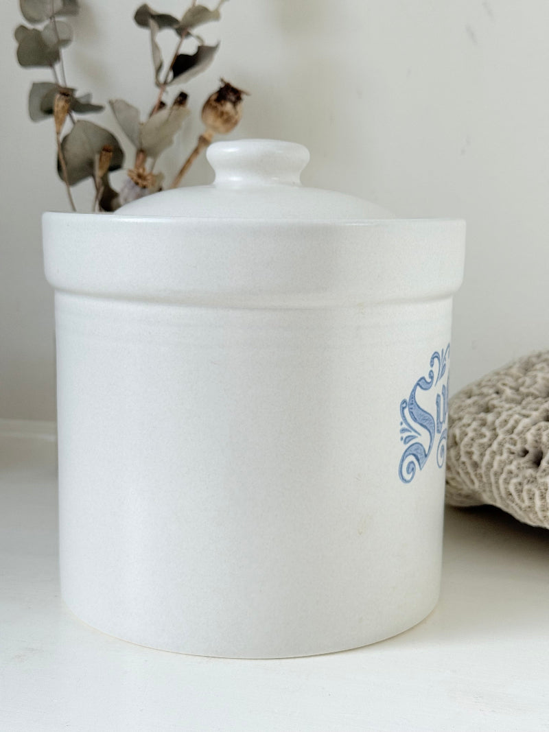 Pfaltzgraff Yorktowne stoneware sugar jar with blue floral motif and lid, photographed on a white surface