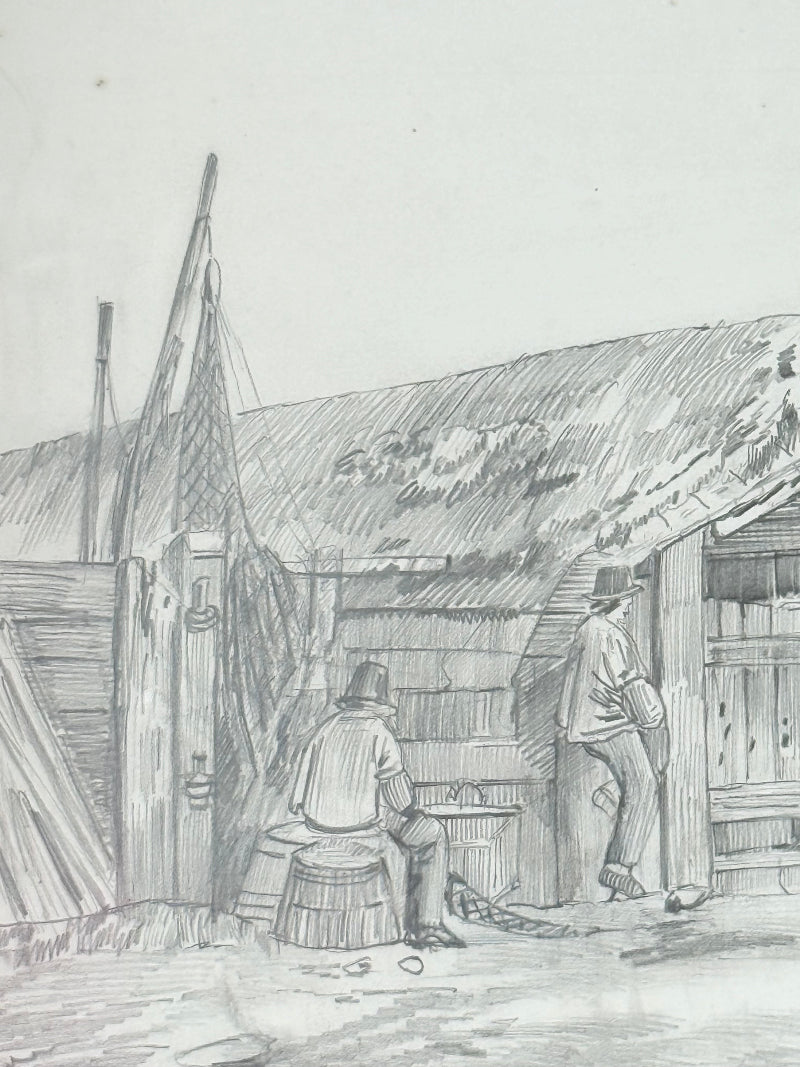 Vintage pencil drawing of rural scene with outbuildings and figures, under glass in black wooden frame, photographed on white surface.