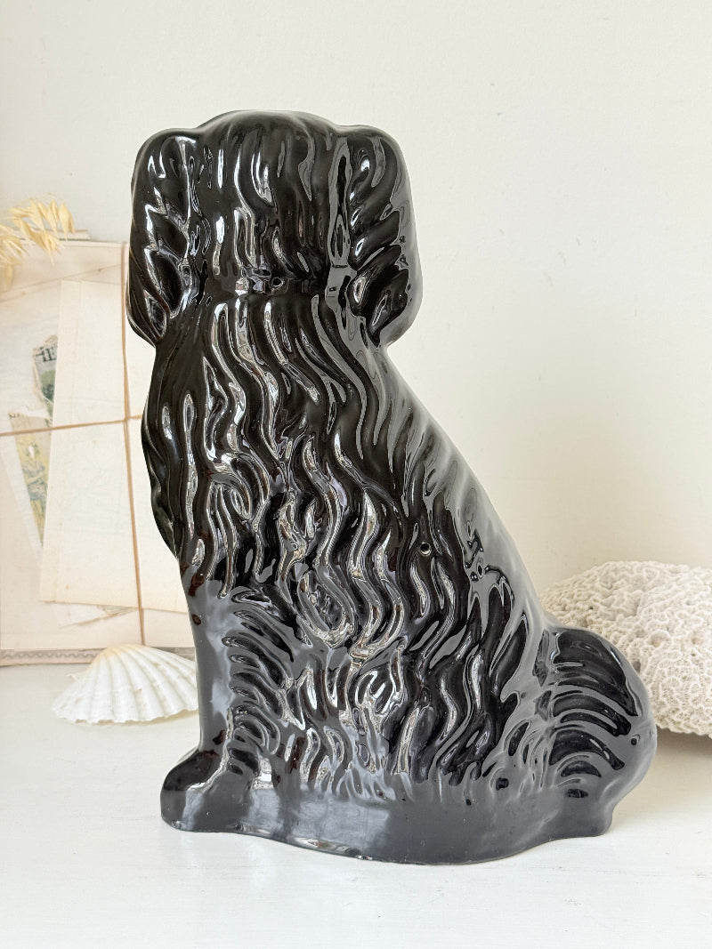 Vintage Staffordshire style black ceramic spaniel dog with gold lustre collar, glossy glaze and textured coat detail
