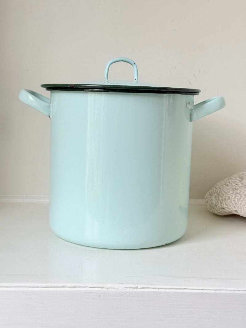 Vintage pale blue enamel bread bin with lid and handles, photographed on a white surface