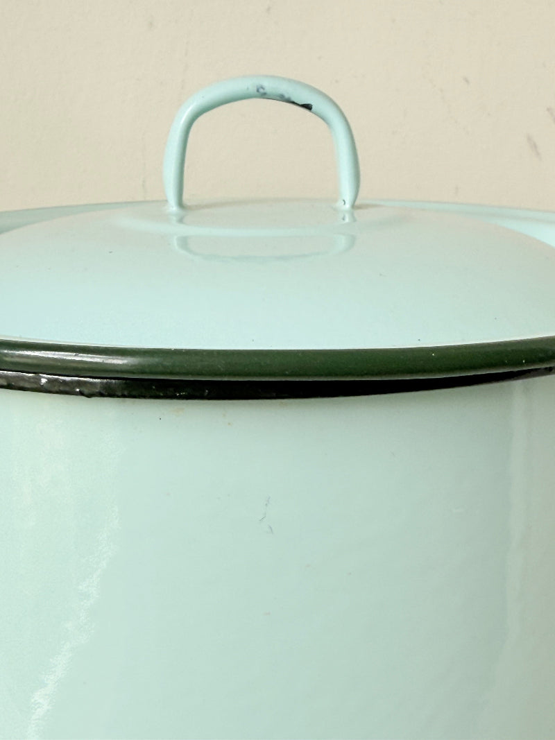 Vintage pale blue enamel bread bin with lid and handles, photographed on a white surface