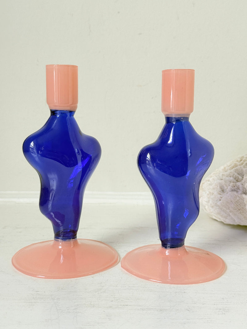 Pair of &Klevering Amsterdam Flux glass candle holders in dark blue and pink with pink taper candles