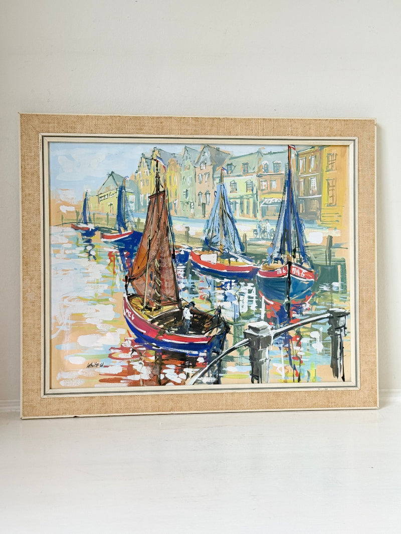 Mid century harbour scene painting with pastel boats and buildings, in wooden frame, photographed on a white surface