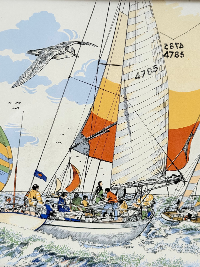 Vintage enamel artwork of sailing yachts with colourful striped sails in a regatta, framed in wood, photographed on white surface.