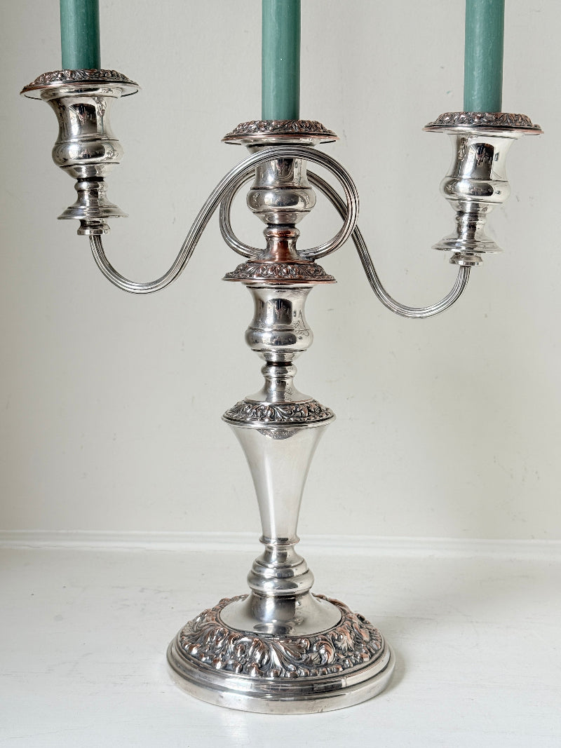 Pair of convertible silver plate on copper candelabra with repoussé detail, removable arms and green taper candles