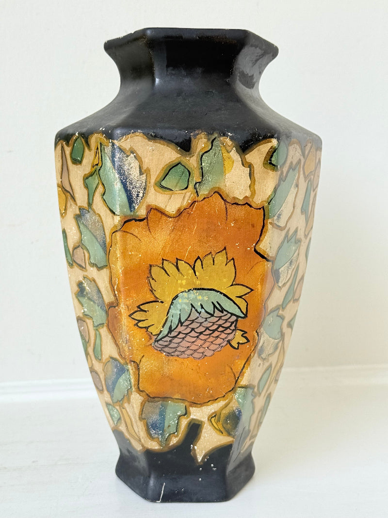Art Deco Brentleigh Ware vase with hand painted floral design in orange, yellow, and teal on a black ground, photographed on a white surface