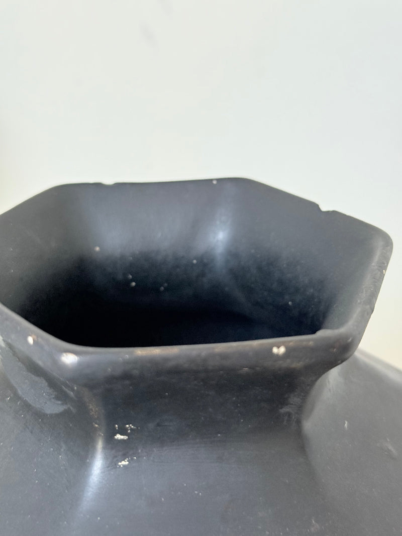 Art Deco Brentleigh Ware vase with hand painted floral design in orange, yellow, and teal on a black ground, photographed on a white surface