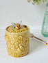 Secla pottery honey jar with lid, bee motif, and wooden honey spoon, made in Portugal, photographed on a white surface