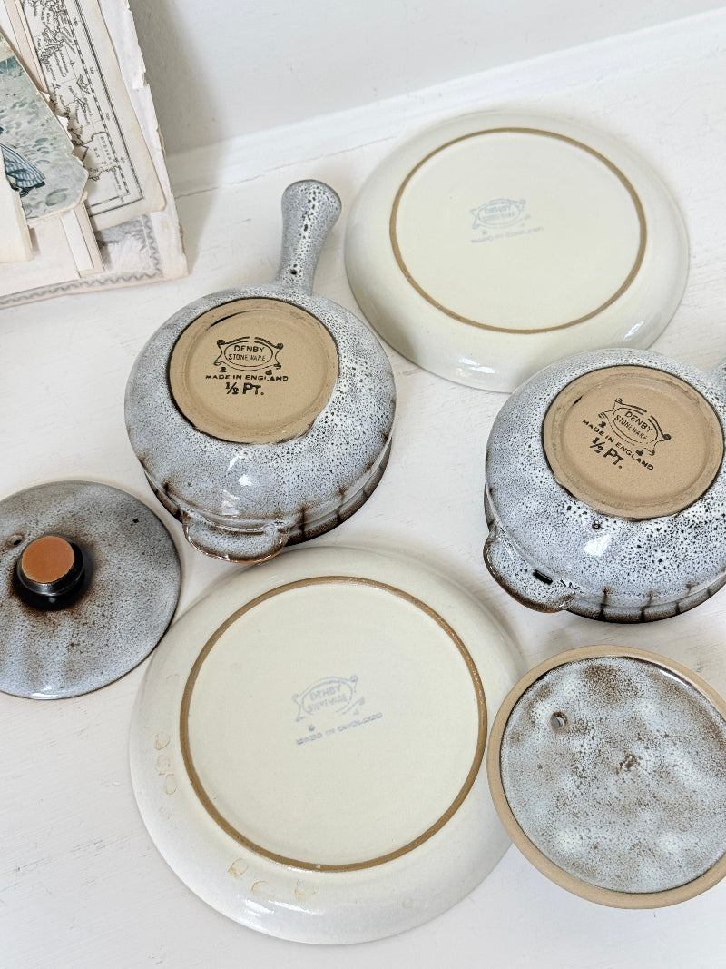 Denby Studio pair of lidded soup bowls with stands in grey and rust photographed on a white surface
