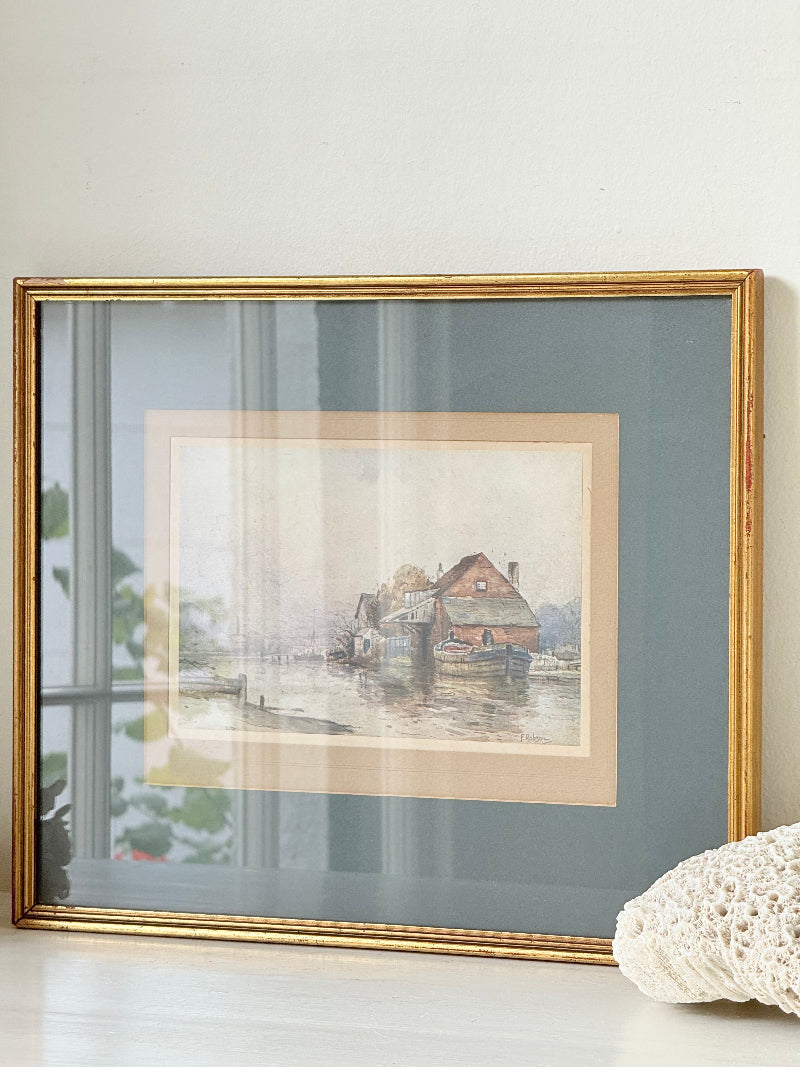 Vintage framed print of riverside mill by F Robson, gilt frame with blue mount, rustic water scene, photographed on white surface.