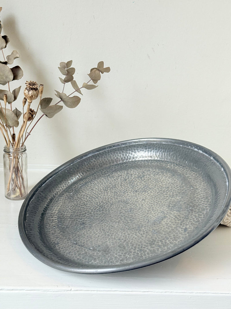 Vintage Harrods pewter drinks tray with hammered surface photographed on a white background.