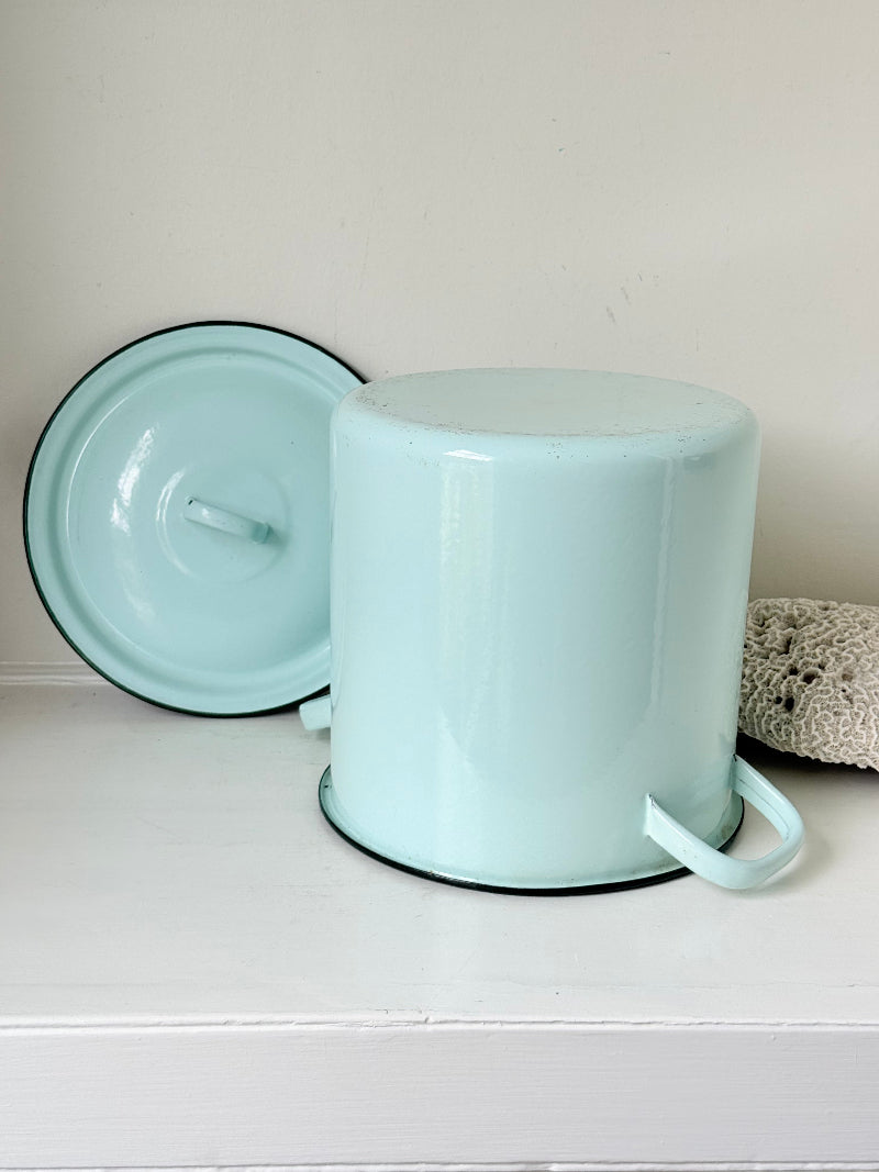 Vintage pale blue enamel bread bin with lid and handles, photographed on a white surface