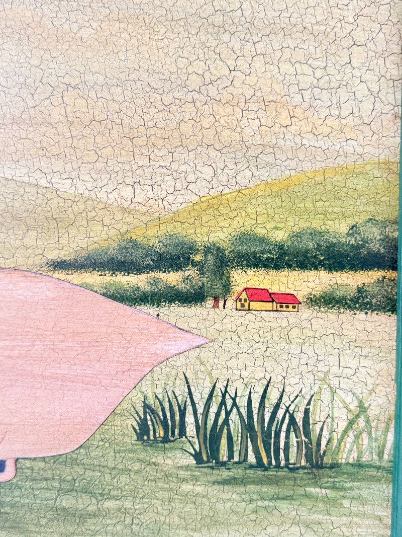 A square ceramic tile featuring a hand-painted folk art landscape with a pink bird silhouette in the foreground, green reeds, a small house with a red roof, and a cracked glaze texture.