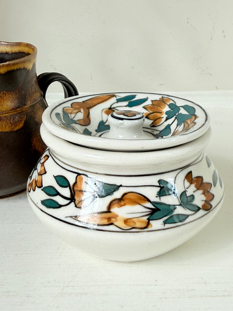 Studio pottery creamer and hand painted sugar bowl set, photographed on a white surface