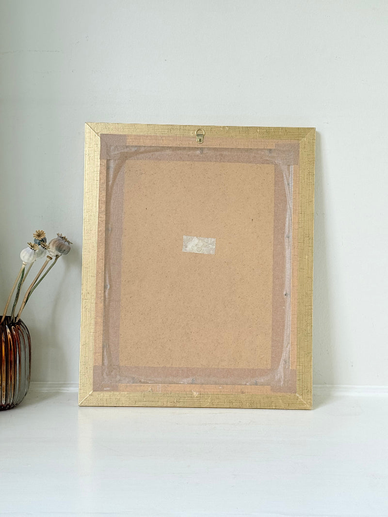 Vintage pastel portrait of a woman in profile wearing red and yellow, framed under glass, photographed on a white surface