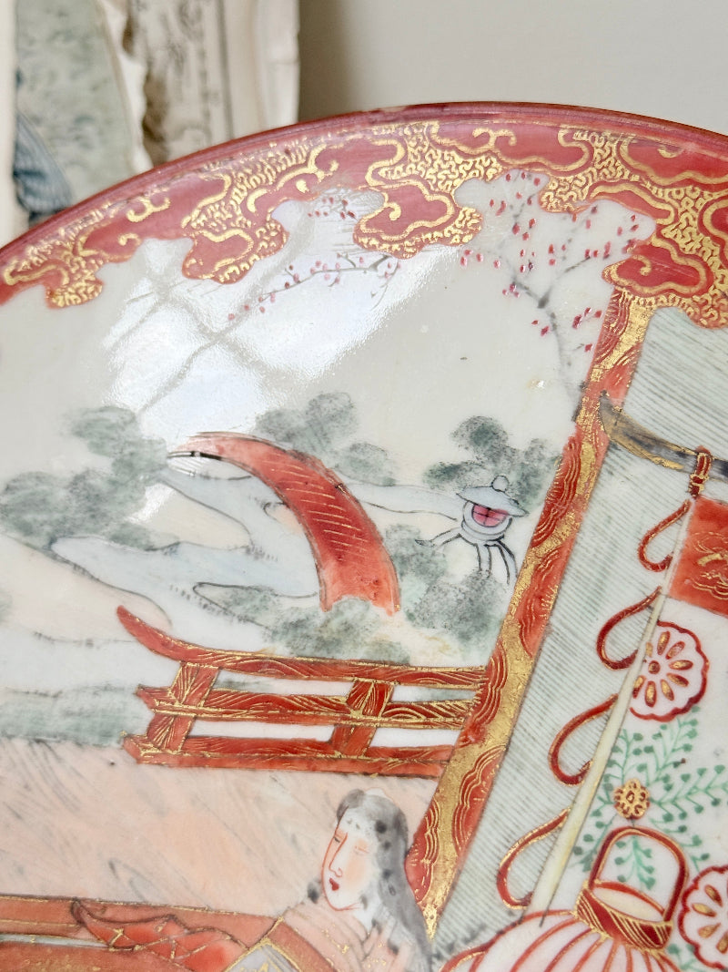 Japanese Kutani porcelain dish hand painted with a garden pavilion scene in iron red and gold