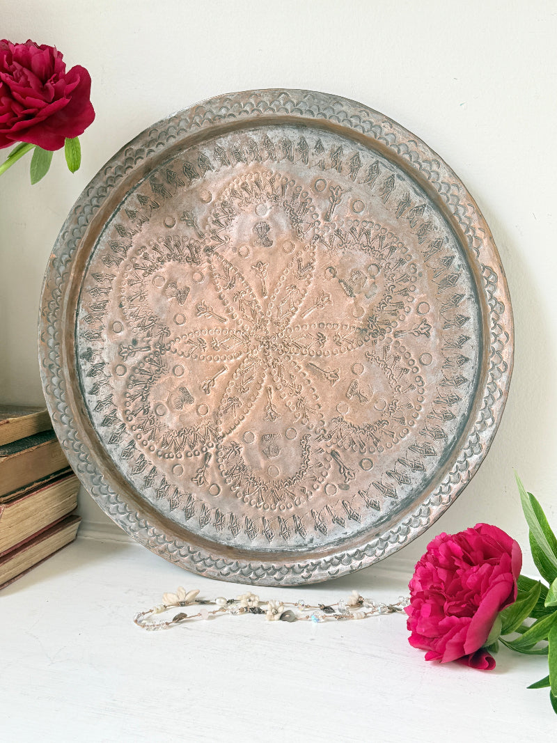 Vintage hand engraved copper tray with sunburst centre, decorative border and aged verdigris patina for wall or tabletop styling