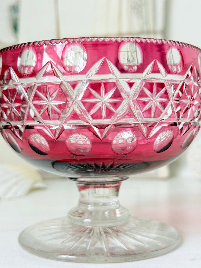 Antique cranberry cut to clear glass pedestal bowl with star and diamond pattern, clear foot and rich pink glass