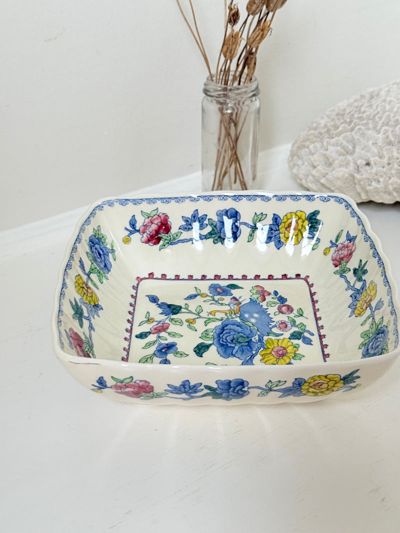 Vintage Mason’s ironstone serving dish with square form and spring floral pattern in blue, pink, yellow, and green, photographed on a white surface