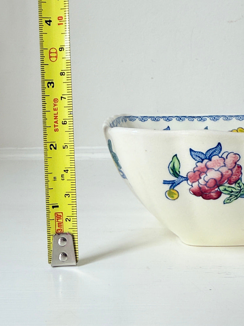 Vintage Mason’s ironstone serving dish with square form and spring floral pattern in blue, pink, yellow, and green, photographed on a white surface