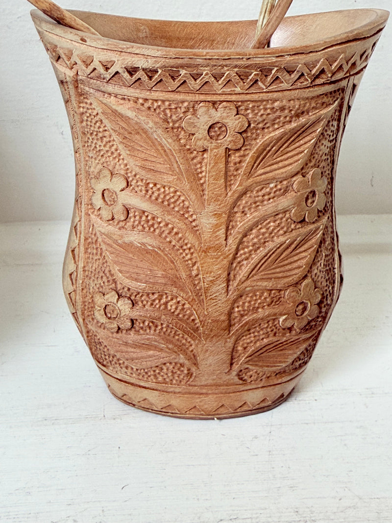 Pair of hand carved wooden jug and vase in contrasting light and dark tones, styled with dried poppy heads on a white surface.