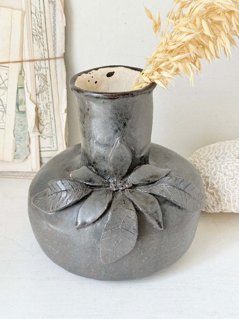 Studio pottery ceramic vase with liquorice grey glaze, applied floral and leaf detail and rounded handmade form