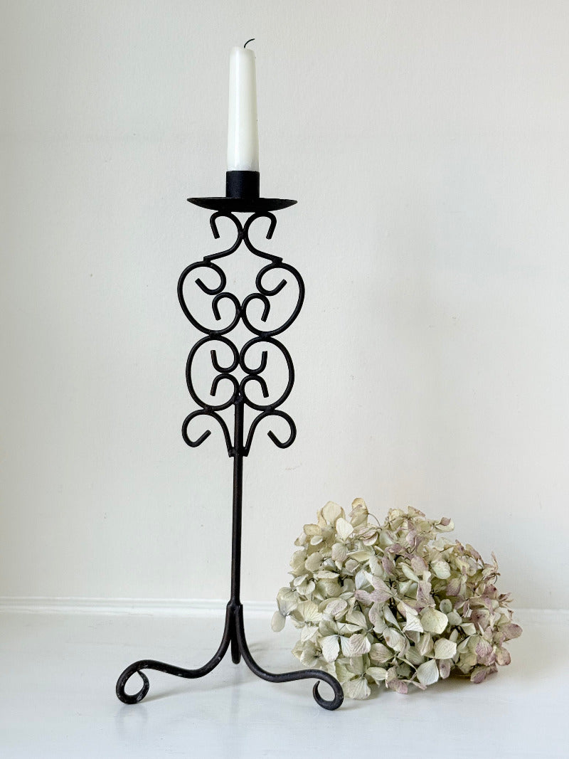 Vintage metal candlestick with scrollwork design and tripod base, 40 cm tall, styled with white taper candle.