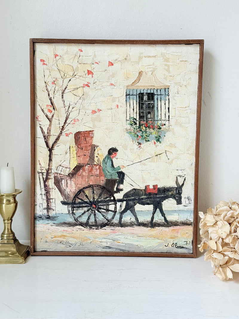 Vintage framed oil painting of horse and cart scene signed L. Cabanes photographed on a white surface