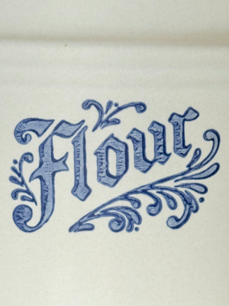 Pfaltzgraff Yorktowne stoneware flour pot with blue floral motif and lid, photographed on a white surface