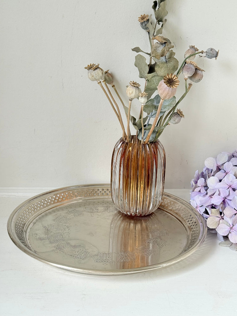 Vintage round silver plate tray with brass rim, pierced edge and etched central motif, photographed on white surface